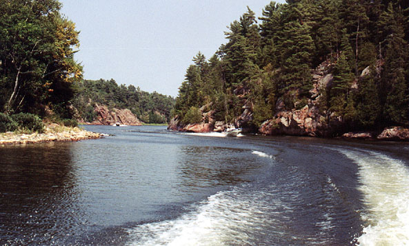 [Photo: Boats at high speed through Collins Inlet gorge.}