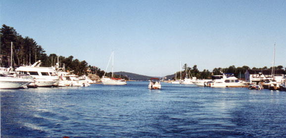[Photo: View to the north from Killarney Channel. LaCloche Mountains in the distance. Many yachts in harbour.]