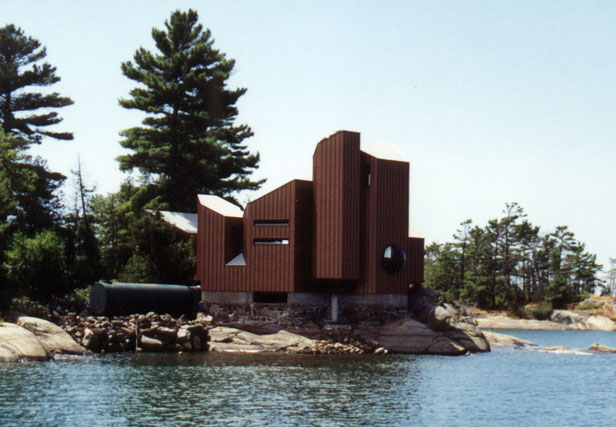 [Photo: Large home with very modern architecture on rocky coastal site.]