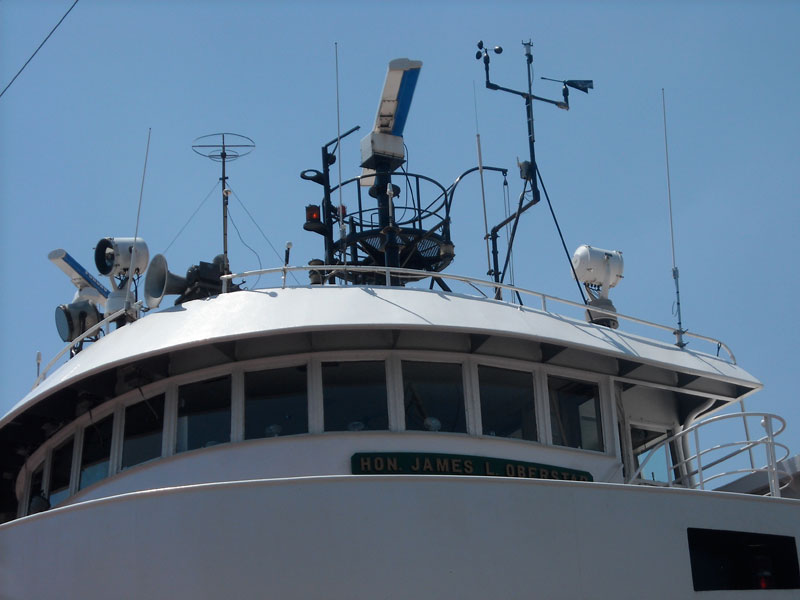 Photo: Close-up of antennas, RADAR, spotlights, horn, and searchlights on superstructure of HON. JAMES L. OBERSTAR
