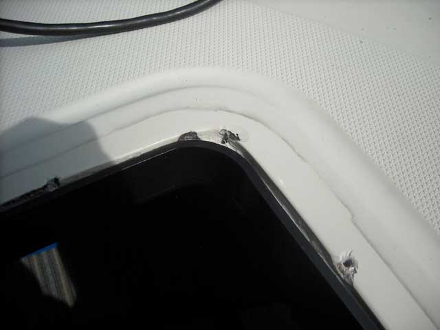 Photo: Mounting area for hatch showing chipped holes from original mounting screws