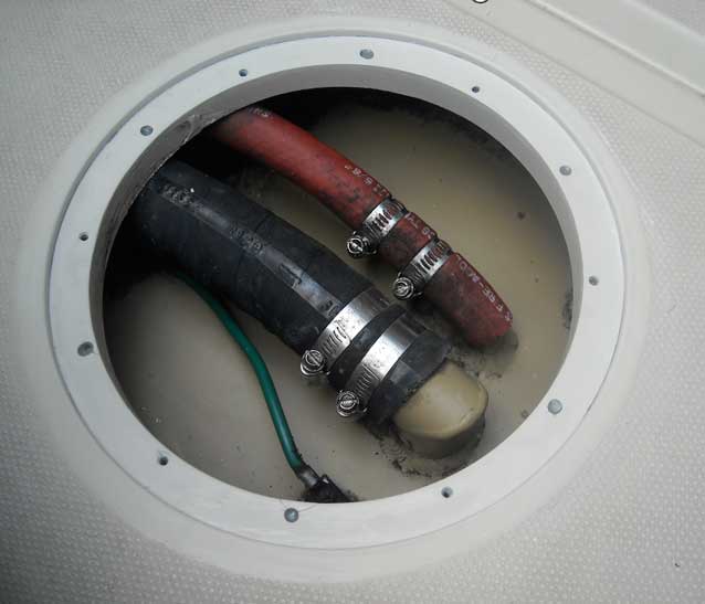 Deck of Boston Whaler 22-footer showing access hole for installation of pry-out plate.