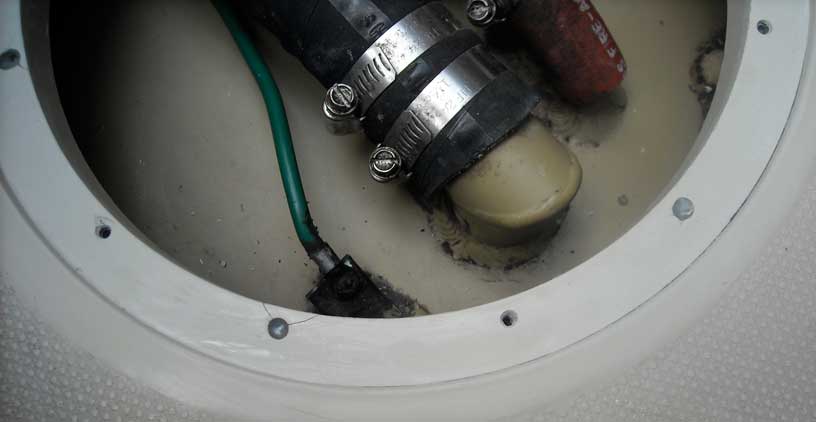 Close-up of deck of Boston Whaler 22-footer showing access hole for installation of pry-out plate.