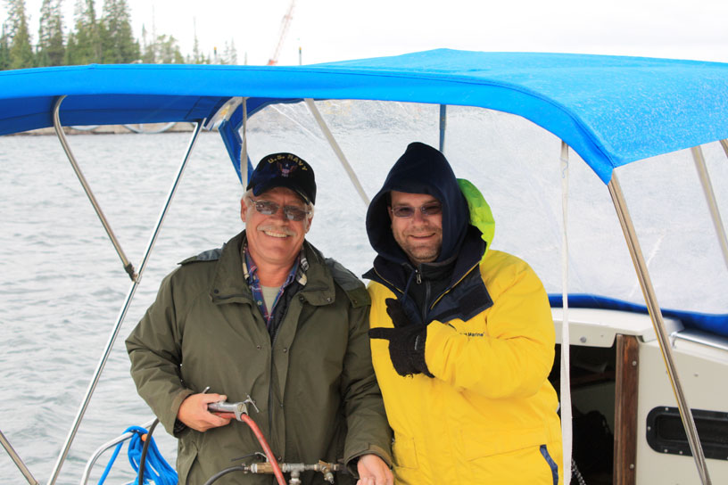 Photo: Dave and Thor at helm of INVICTUS after successful repair, Mott Island, Isle Royale, Lake Superior.