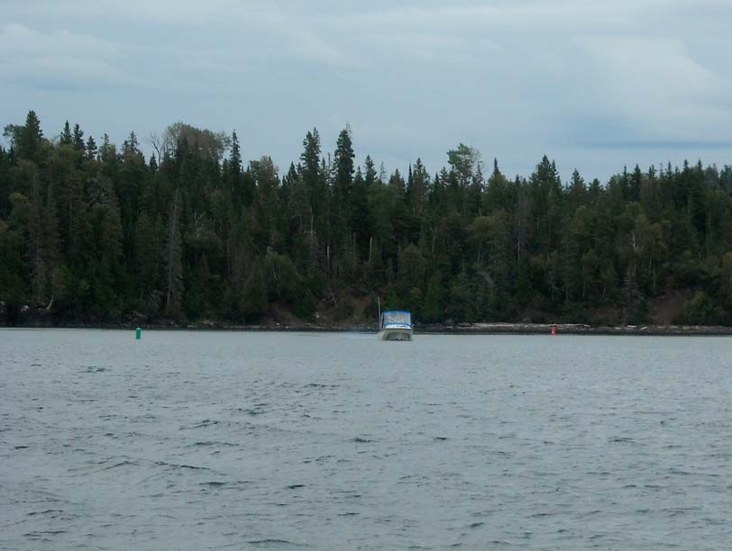Photo: Boston Whaler boat exiting McCargoe Cove to Lake Superior on cloudy, overcast morning.
