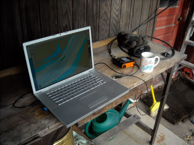 Photo: Laptop computer and AIS receiver on bench in garden.